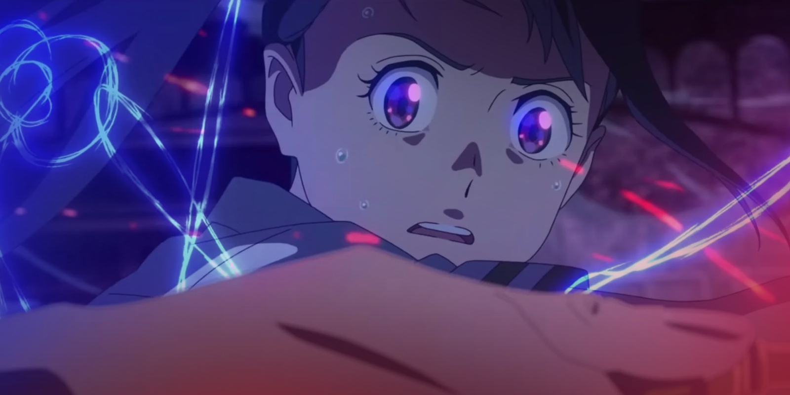 An anime screenshot captures a close-up, high-angle shot of Suzume Iwato from Suzume, looking intensely determined yet anxious as she struggles against an unseen force. Her head is tilted slightly upward, revealing her wide, expressive purple eyes with detailed pink highlights reflecting the glowing environment, framed by thin, dark eyebrows and a few stray strands of dark hair swept across her forehead. Her face is glistening with sweat droplets, her mouth is slightly agape in exertion, and a dark shadow stretches across the upper half of her face, emphasizing the dramatic tension. She wears a muted blue uniform shirt with a dark, striped collar. In the immediate foreground, a large, out-of-focus hand dynamically cuts horizontally across the lower third of the frame, tightly gripping a metallic golden key or handle. Piercing through the scene are vibrant, swirling neon blue light trails that wrap around her torso, mixed with sharp, bright red horizontal sparks that add a sense of chaotic, magical energy. The background is cast in a dark, atmospheric purple and indigo hue, faintly revealing the blurred architecture of an abandoned, cavernous structure. Makoto Shinkai's untitled next anime film has been officially secured for global distribution by Crunchyroll and Sony Pictures Entertainment, though the title, exact plot details, and release date are currently kept under wraps. Shinkai has noted that a domestic announcement and release may not be far off.